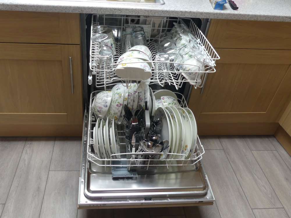 demonstration of dishwasher stacked with all crockery and cutlery